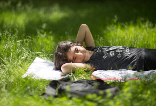 istock Child relaxing in grass on field. 961544370