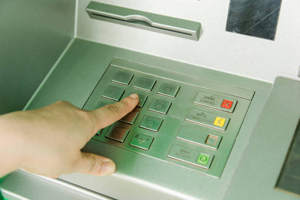 istock Close up of man hand entering password code on ATM bank machine keypad 961544480