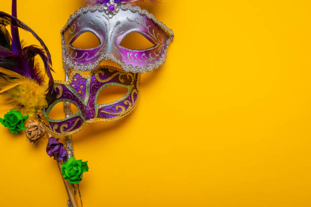 istock Mardi Gras mask with beads on a yellow background 961544752