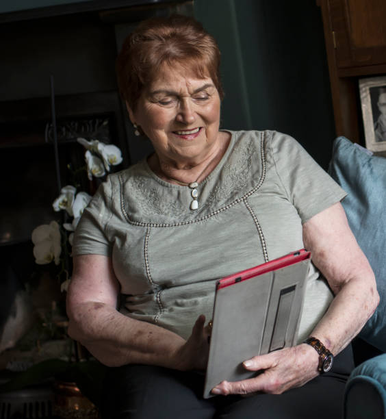 istock elderly lady using a digital tablet in her living room 961545386