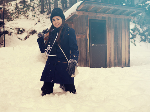 young Asian Woman playing with snow Outdoor Winter Lifestyle happiness.