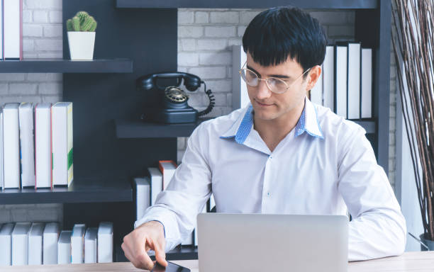 istock Modern Business man is busying using laptop and smartphone. 961546686