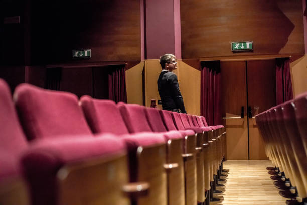 istock Young Man Standing Up in Theatre 961550876
