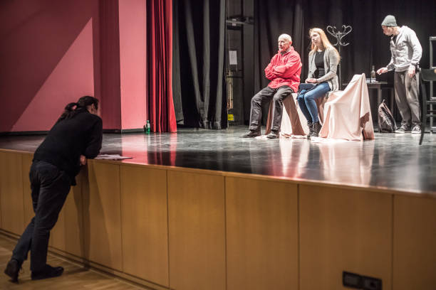 istock Director Reading Script and Supervising During Theatrical Rehearsal 961551056