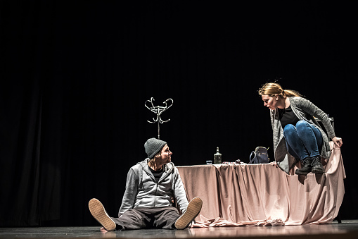 Young Man and Young Woman Acting on Stage.