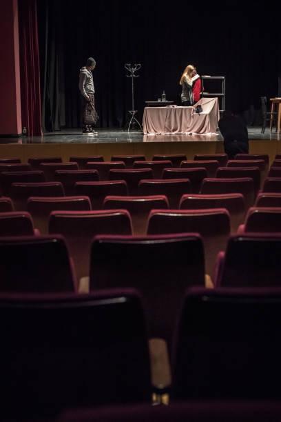 istock Director Reading Script and Supervising During Theatrical Rehearsal 961551072