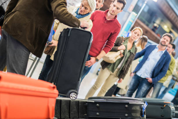 istock Man picking up luggage at airport 961551912