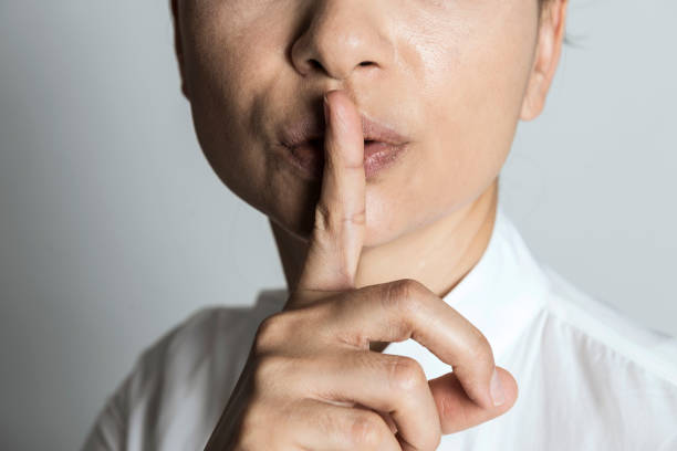 stille - silence finger on lips businesswoman one person stock-fotos und bilder