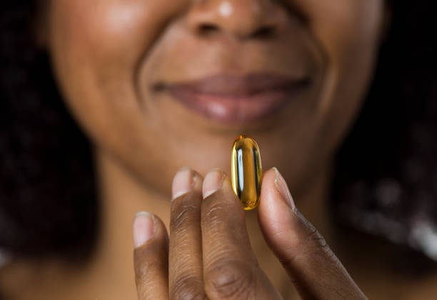 istock African Woman Showing Pill 961552396