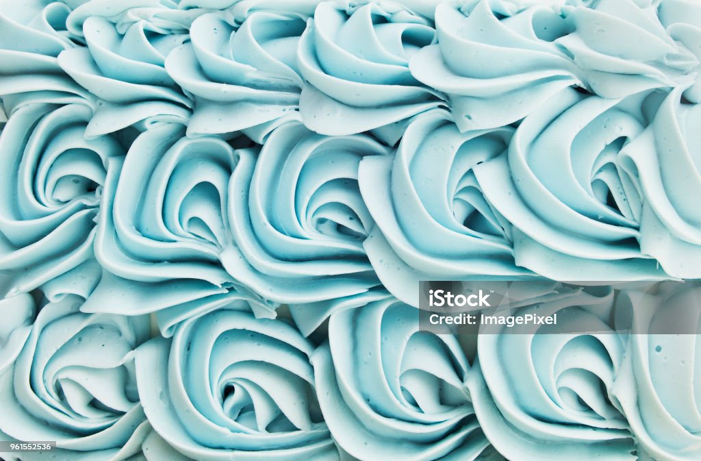 Cake Icing Floral Swirl Background Blue cake icing swirl decoration background pattern. Cake Stock Photo