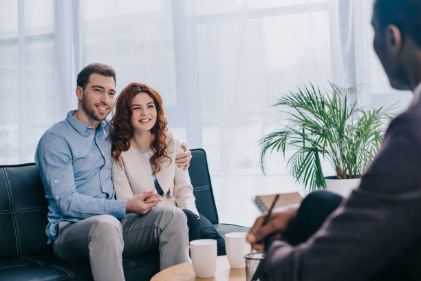 istock Smiling young couple sitting on sofa 961553146