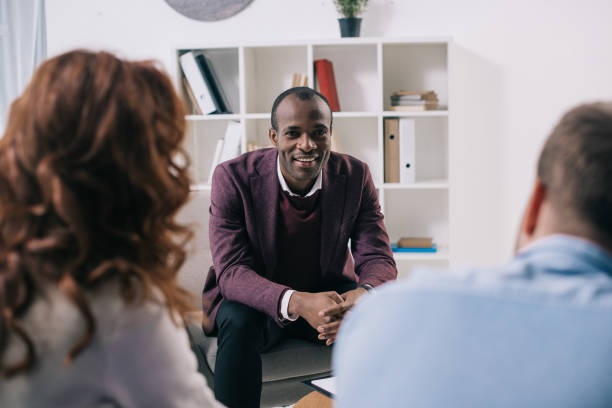 istock Smiling psychiatrist talking to divorcing couple 961553216