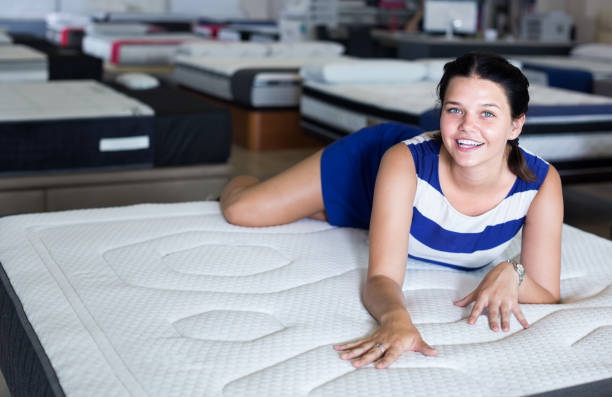 istock positive woman is lying on bed and testing mattress for relax 961553842
