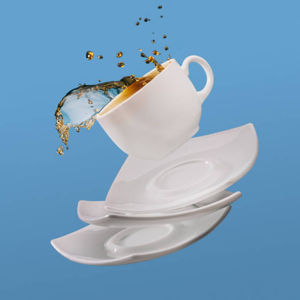 istock Black coffee in cup with saucers falling isolated on blue background 961553962