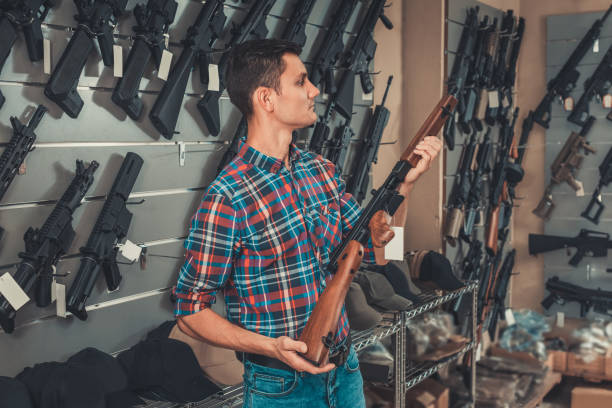 istock Male customer is choosing air-powered gun 961556214