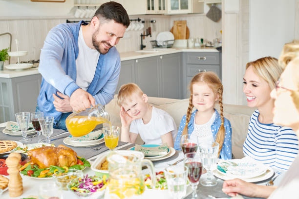 istock Happy Family at Dinner Table 961558900