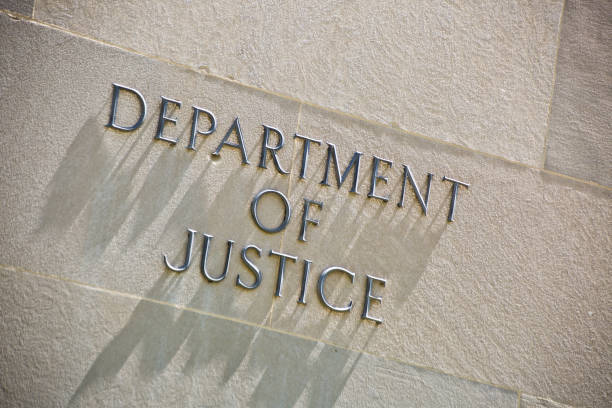 Building Entrance Sign for the Department of Justice in Washington DC The entrance signage for the United States Department of Justice Building in Washington DC, USA. The Department of Justice, the U.S. law enforcement and administration of Justice government agency. entrance sign photos stock pictures, royalty-free photos & images