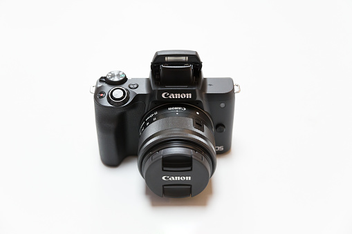 Belgrade, Serbia - May 05, 2018: New Canon mirrorless, interchangeable lens camera, EOS M50 with 15-45 mm zoom lens is displayed on white background