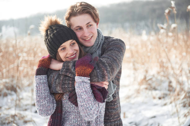 istock Cheerful young couple having fun in winter park 961568184