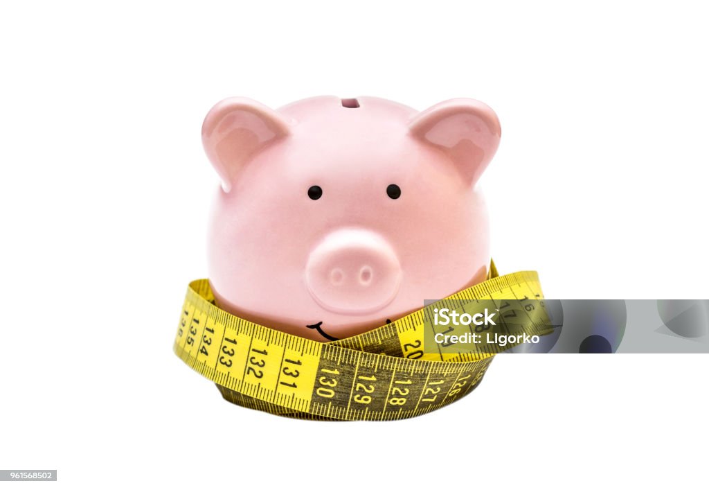 Piggy bank with measure tape on white background. Tape Measure Stock Photo