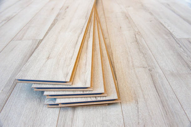 Light laminate on the floor with some laminate left after work Light laminate on the floor with some laminate left after work wood laminate flooring photos stock pictures, royalty-free photos & images