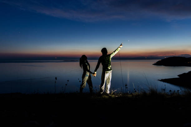 istock Couple holding hands and looking at stars 961572924