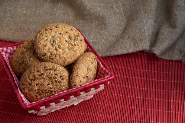istock Savory cookies sprinkled with sesame seeds, sunflower on table and burlap background 961585326
