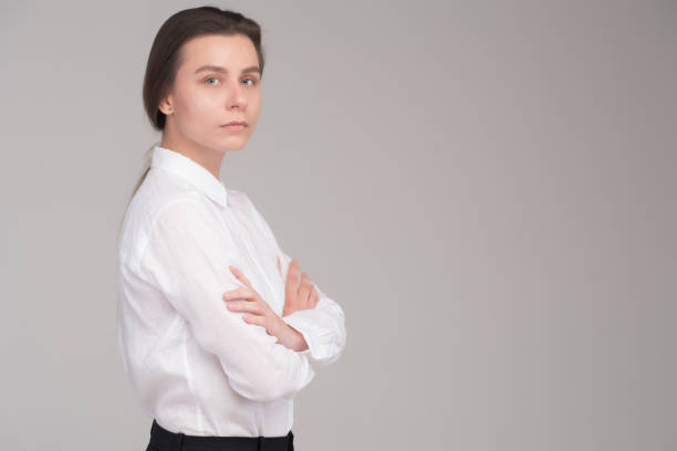 istock Serious business girl with folded arms isolated 961591422