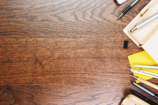 Wooden office desk with supplies and copy space. Mock up, Above view and close up