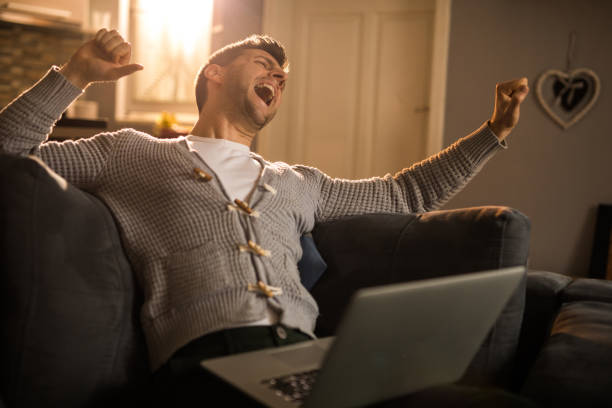 istock Men is happy about something on laptop 961599360