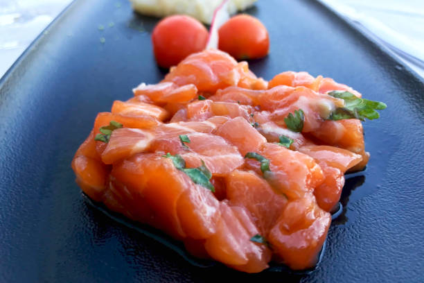 istock tartare with salmon on a black plate. 961599642