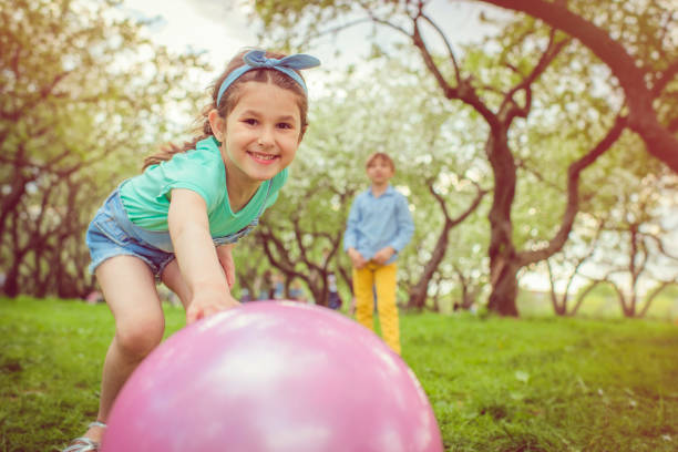 istock Little girl and boys playing with ball 961606976