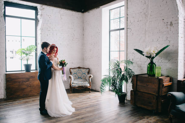 istock newlyweds are standing and hugging in the loft 961607232