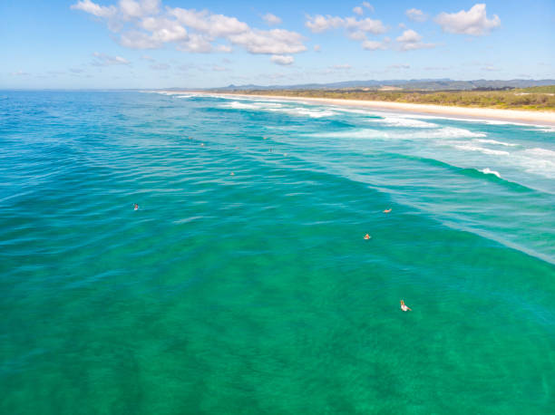 australian coastline with surfers - cabarita beach imagens e fotografias de stock