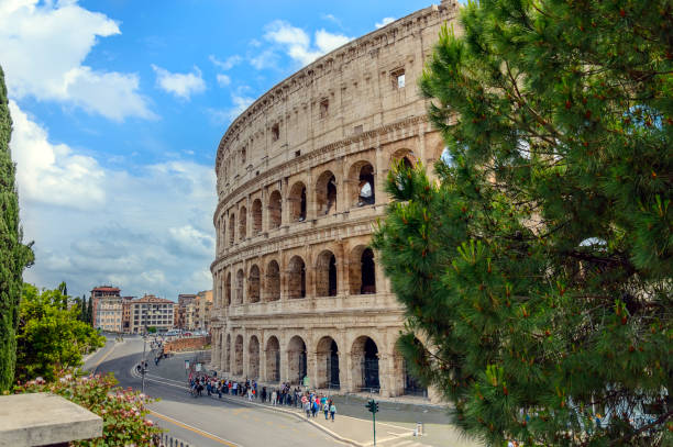istock Colosseum or Coliseum in Rome, Italy with a tree and blue sky. 961613162