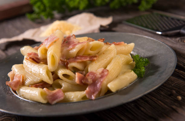 istock Pasta with cheese sauce and bacon 961619616