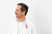 Man wearing aids awareness ribbon