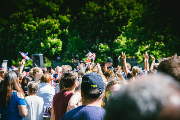 Vintage style Union Jack flag flying in front of VE Day celebrations at a social distance street party in May 2020