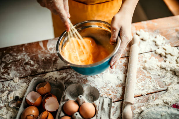 Eggs for desert Kid mixing eggs for cake wire whisk stock pictures, royalty-free photos & images
