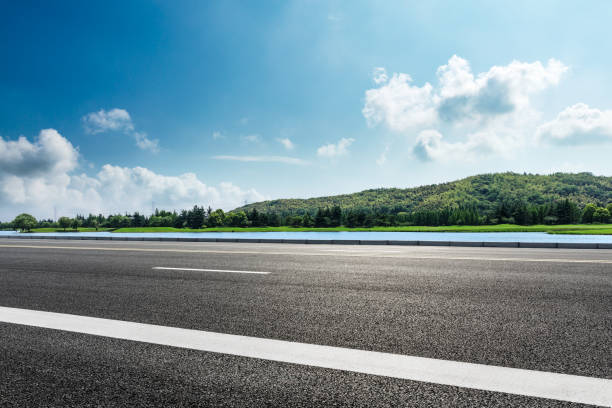 istock asphalt road and mountains with sky clouds landscape 961632342