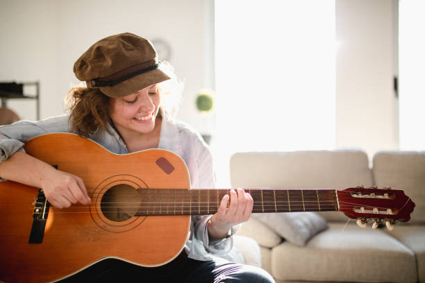 istock Woman playing guitar and enjoying 961632782