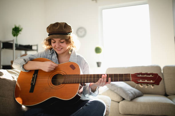 istock Woman playing guitar and enjoying 961632816