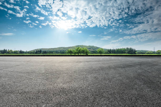 istock Asphalt square road and hills with clouds landscape 961632822