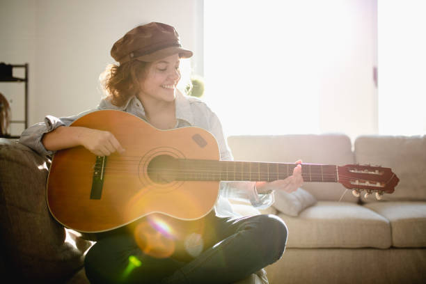 istock Woman playing guitar and enjoying 961632920