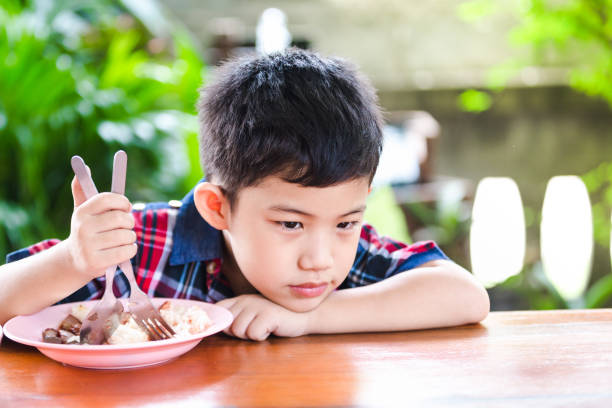 istock Asian little boy boring eating 961633028