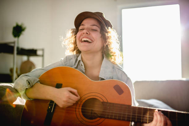 istock Woman playing guitar and enjoying 961633200