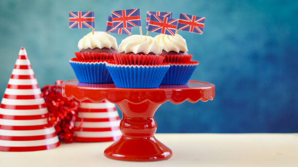 istock Red white and blue theme cupcakes and cake stand with UK Union Jack flags 961633444
