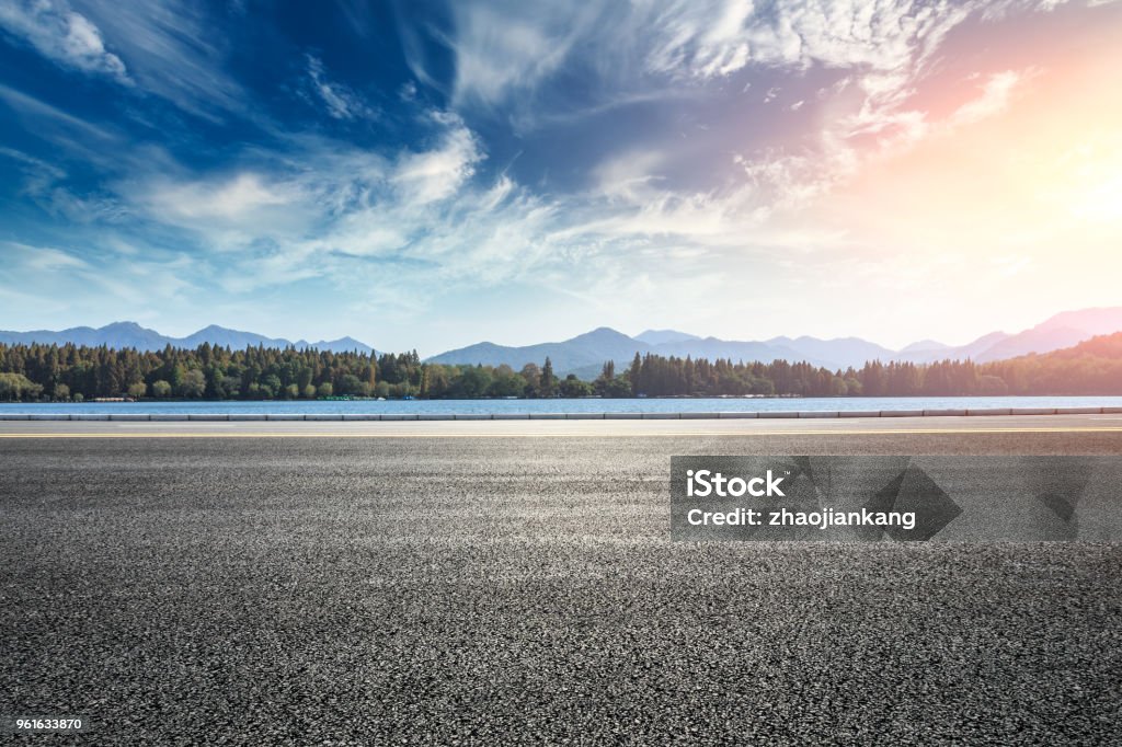 Asphalt road and hills with clouds landscape at sunset Asphalt road and hills with sky clouds landscape at sunset Road Stock Photo