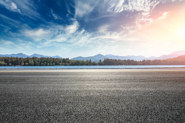 Asphalt road and hills with clouds landscape at sunset Asphalt road and hills with sky clouds landscape at sunset sky land stock pictures, royalty-free photos & images