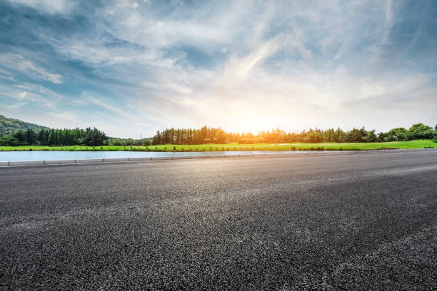 istock Asphalt road and forest with sky clouds landscape at sunset 961633978